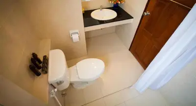 a small bathroom with a toilet and a sink at The Meet Green Apartment in Bangkok