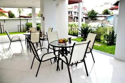 a dining room with a table and chairs at The Meet Green Apartment in Bangkok
