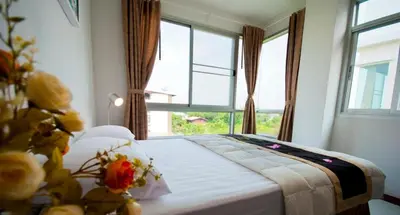 a bedroom with a bed with a large window at The Meet Green Apartment in Bangkok