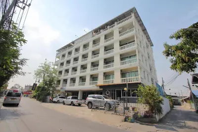 a large white building on the side of a street at Super OYO 498 Ladawan Villa in Bangkok
