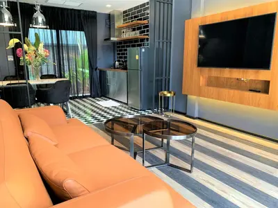 a living room with a couch and a table at The Matta in Bangkok