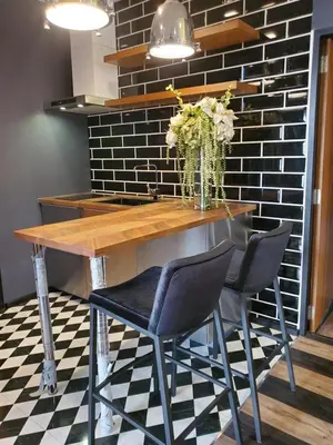 a table with two chairs and a vase of flowers at The Matta in Bangkok