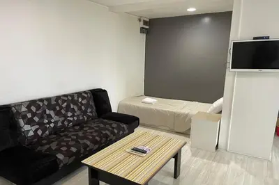 a living room with a couch and a table at Sakun Place in Bangna