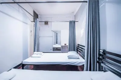 a hospital room with two beds and a mirror at Ali Hostel in Bangkok