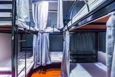 a group of bunk beds in a room at Ali Hostel in Bangkok