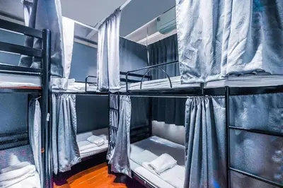 a group of bunk beds in a room at Ali Hostel in Bangkok