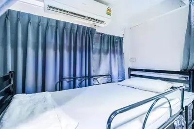 a hospital room with two beds and a window at Ali Hostel in Bangkok