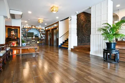an empty lobby with a potted plant in the middle at The Krungkasem Srikrung Hotel in Bangkok