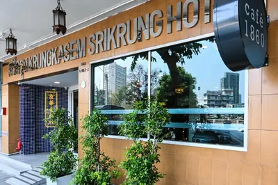 a building with a window with plants in it at The Krungkasem Srikrung Hotel in Bangkok