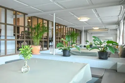 a table with plants on it in a room at The Krungkasem Srikrung Hotel in Bangkok