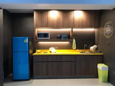 a kitchen with a yellow counter and a blue refrigerator at S1hostel Bangkok in Bangkok