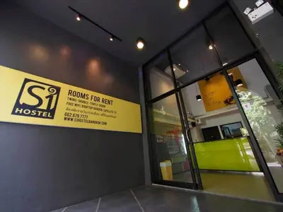 a building with a sign on the side of it at S1hostel Bangkok in Bangkok