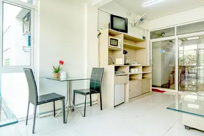 a dining room with a table and chairs at Riski Residence Bangkok-noi - Wasit Apartment in Bangkok