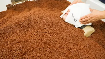 a person is scrubbing a pile of brown carpet at The Square 101 in Bangkok