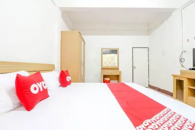 a bedroom with a large white bed with red pillows at OYO 525 MRT Phetkasem 48 -1 Place in Bangkok