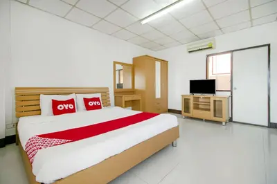 a bedroom with a large bed and a tv at OYO 525 MRT Phetkasem 48 -1 Place in Bangkok