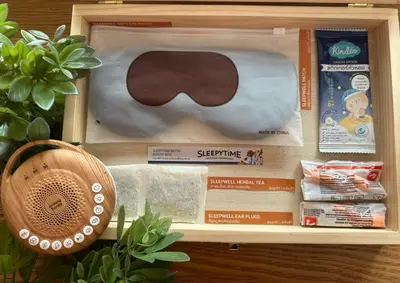 a wooden box with a pair of sunglasses and other items at Fullroom 77 Srinakarin in Samutprakarn