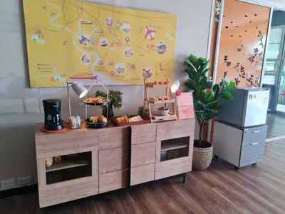 a wooden buffet with food on it in a room at Fullroom 77 Srinakarin in Samutprakarn