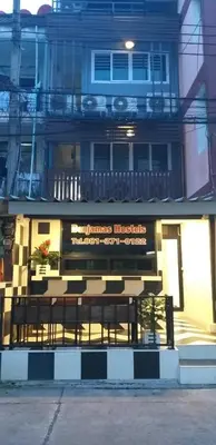 a bench sitting in front of a building at Benjamas hostels in Bangkok