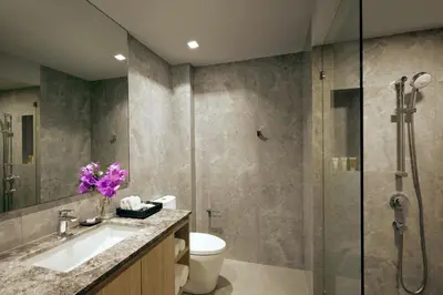 a bathroom with a shower and a toilet and a sink at Somerset Rama 9 Bangkok in Bangkok