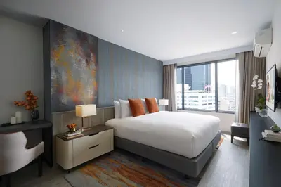 a bedroom with a white bed and a large window at Somerset Rama 9 Bangkok in Bangkok