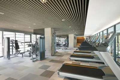 a gym with treadmills and cardio equipment in a building at Somerset Rama 9 Bangkok in Bangkok