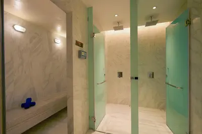 a shower with a glass door in a bathroom at Somerset Rama 9 Bangkok in Bangkok