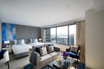 a hotel room with a bed and a couch at Somerset Rama 9 Bangkok in Bangkok