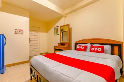 a bedroom with a large bed with red pillows at OYO 583 Sweethome Guest House in Bangkok Noi