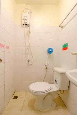 a bathroom with a toilet and a sink at OYO 583 Sweethome Guest House in Bangkok Noi