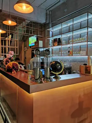 a bar in a restaurant with people in the background at Ratchada Hotel - ROTFAI in Bangkok