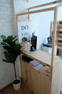 a wooden desk with a plant in a room at Ratchada Hotel - ROTFAI in Bangkok
