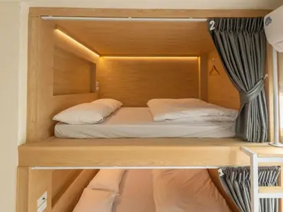 a bunk bed in a room with a bedvisor at Ratchada Hotel - ROTFAI in Bangkok