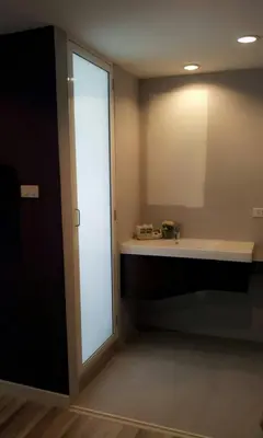 a bathroom with a sink and a mirror at Nantra Ploenchit hotel in Bangkok