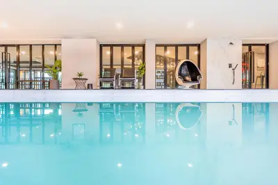 a swimming pool in the middle of a building at 56 Hotel in Bangna