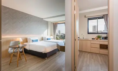 a hotel room with a bed and a sink at 56 Hotel in Bangna
