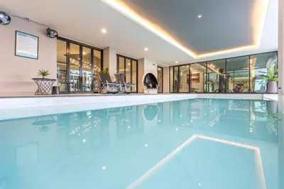 a large swimming pool in a building at 56 Hotel in Bangna