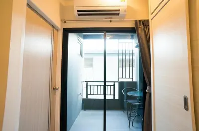 a door leading into a room with a balcony at DB PLUS 6 in Bangkok