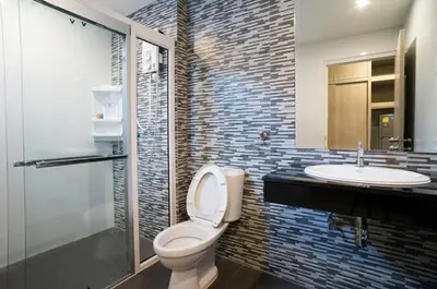 a bathroom with a toilet and a sink at DB PLUS 6 in Bangkok