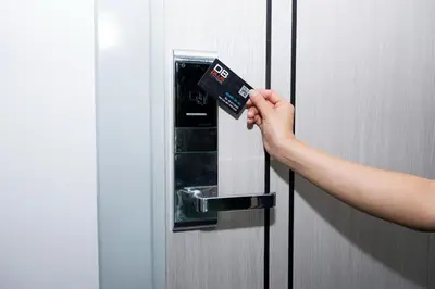 a person holding a credit card in an elevator door at DB PLUS 6 in Bangkok