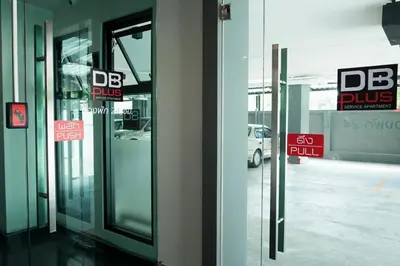 a glass door of a building with signs on it at DB PLUS 6 in Bangkok