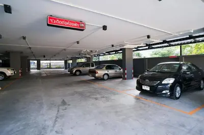 a parking lot with several cars parked in it at DB PLUS 6 in Bangkok
