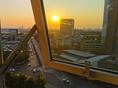 a view from a window of a city at sunset at Ekkamai+Thong Lor in Bangkok