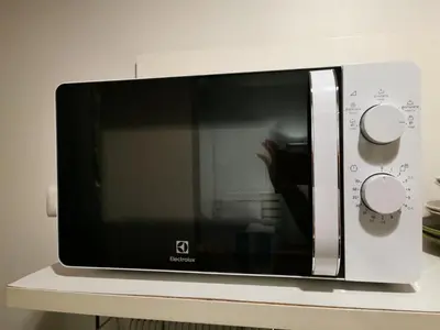 a microwave oven sitting on top of a counter at Ekkamai+Thong Lor in Bangkok