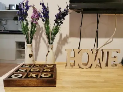 a table with vases and a box of donuts and a sign that reads at Ekkamai+Thong Lor in Bangkok