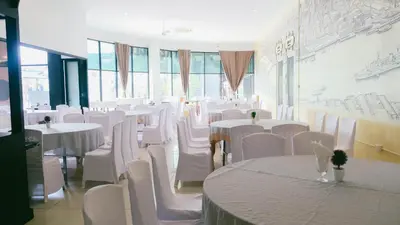 a dining room with white tables and white chairs at VARIMANTRA HOTEL in Nakhon Pathom