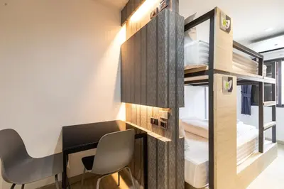 a room with a desk and a room with a bedroom at Baan Kun Mhor Hostel บ้านคุณหมอโฮสเทล in Bangkok
