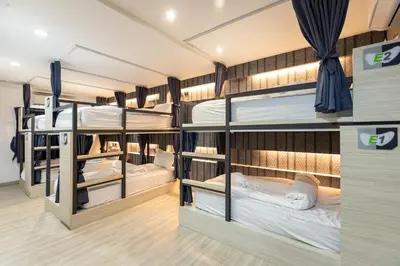 a group of bunk beds in a room at Baan Kun Mhor Hostel บ้านคุณหมอโฮสเทล in Bangkok