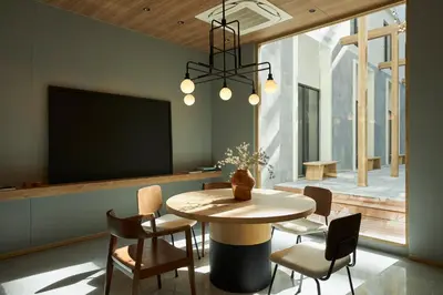 a dining room with a table and chairs and a tv at ASAI Bangkok Chinatown in Bangkok