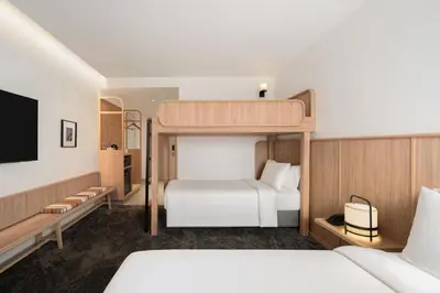 a bedroom with a bunk bed and a tv at ASAI Bangkok Chinatown in Bangkok